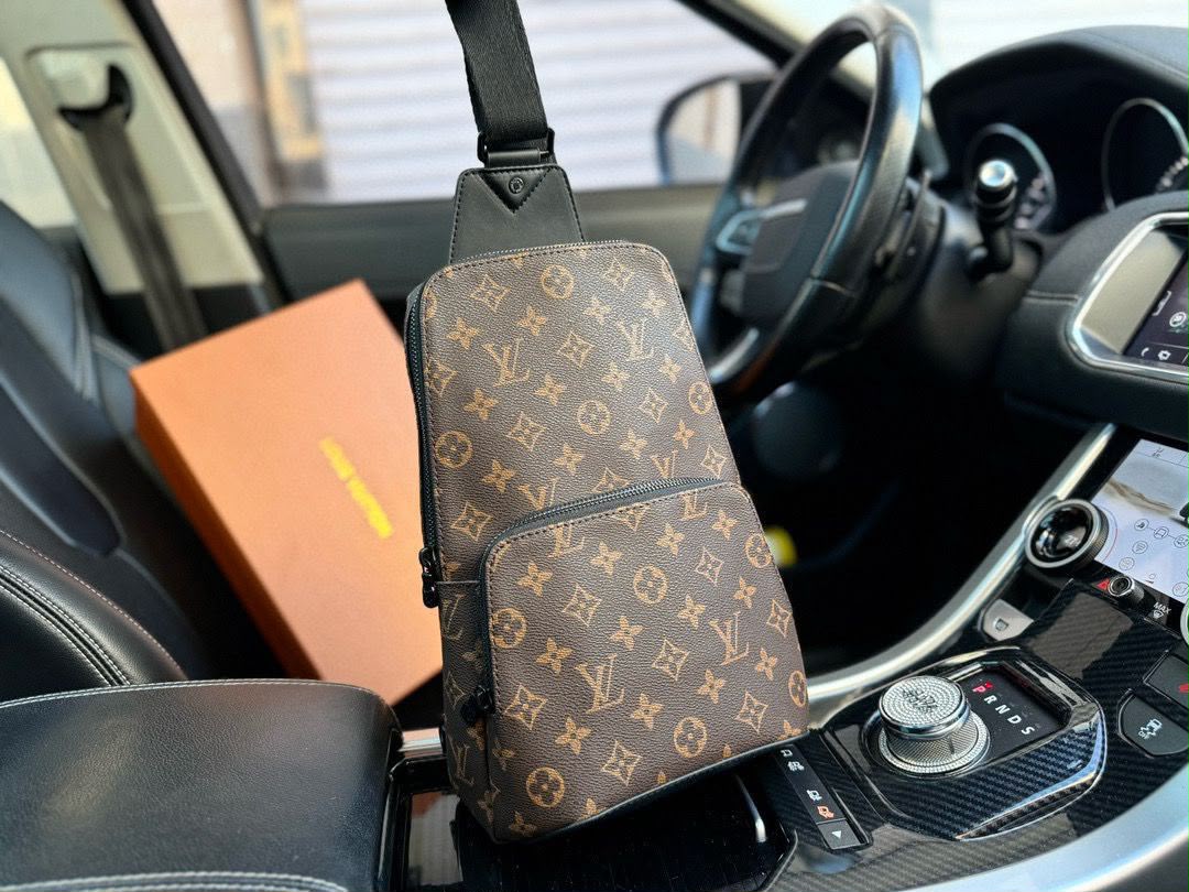 A Louis Vuitton monogram shoulder bag in brown coated canvas with a black strap